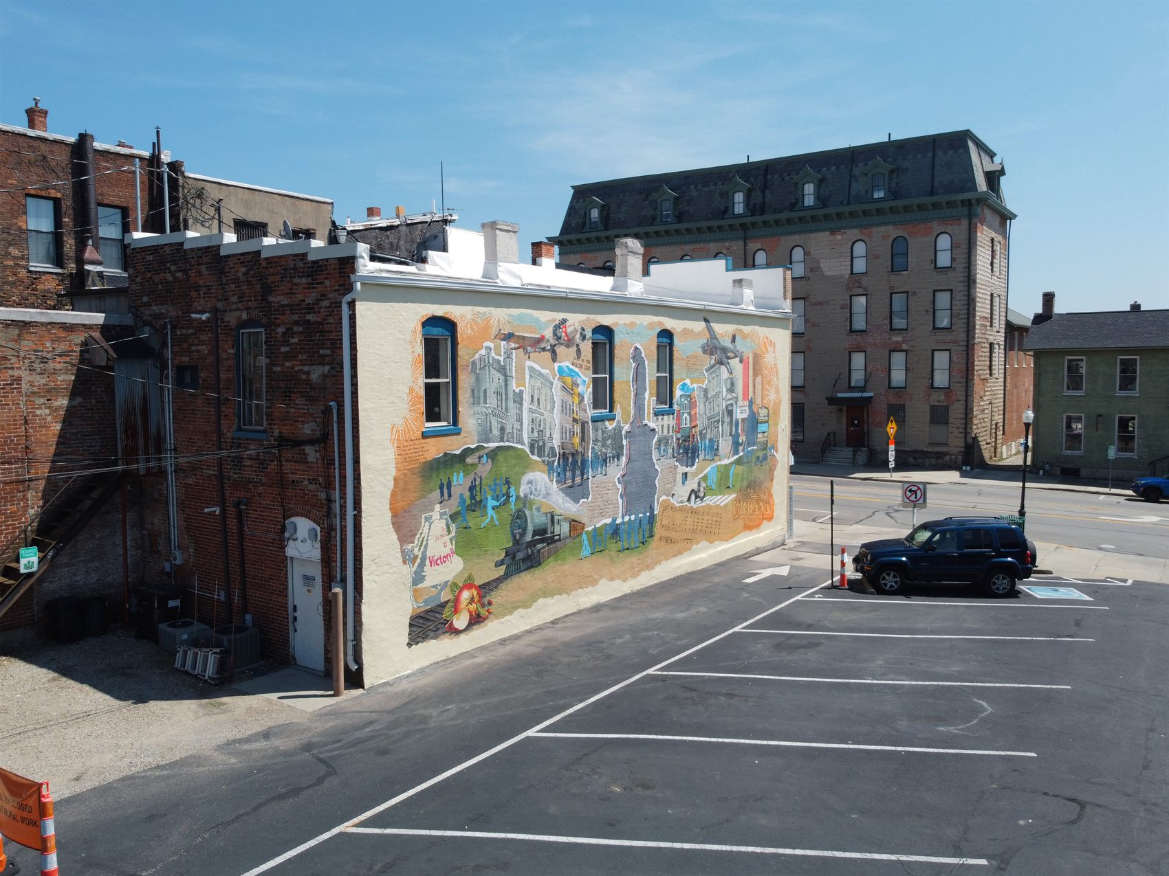 Aerial view of the finished Urbana Mural spanning a large downtown wall